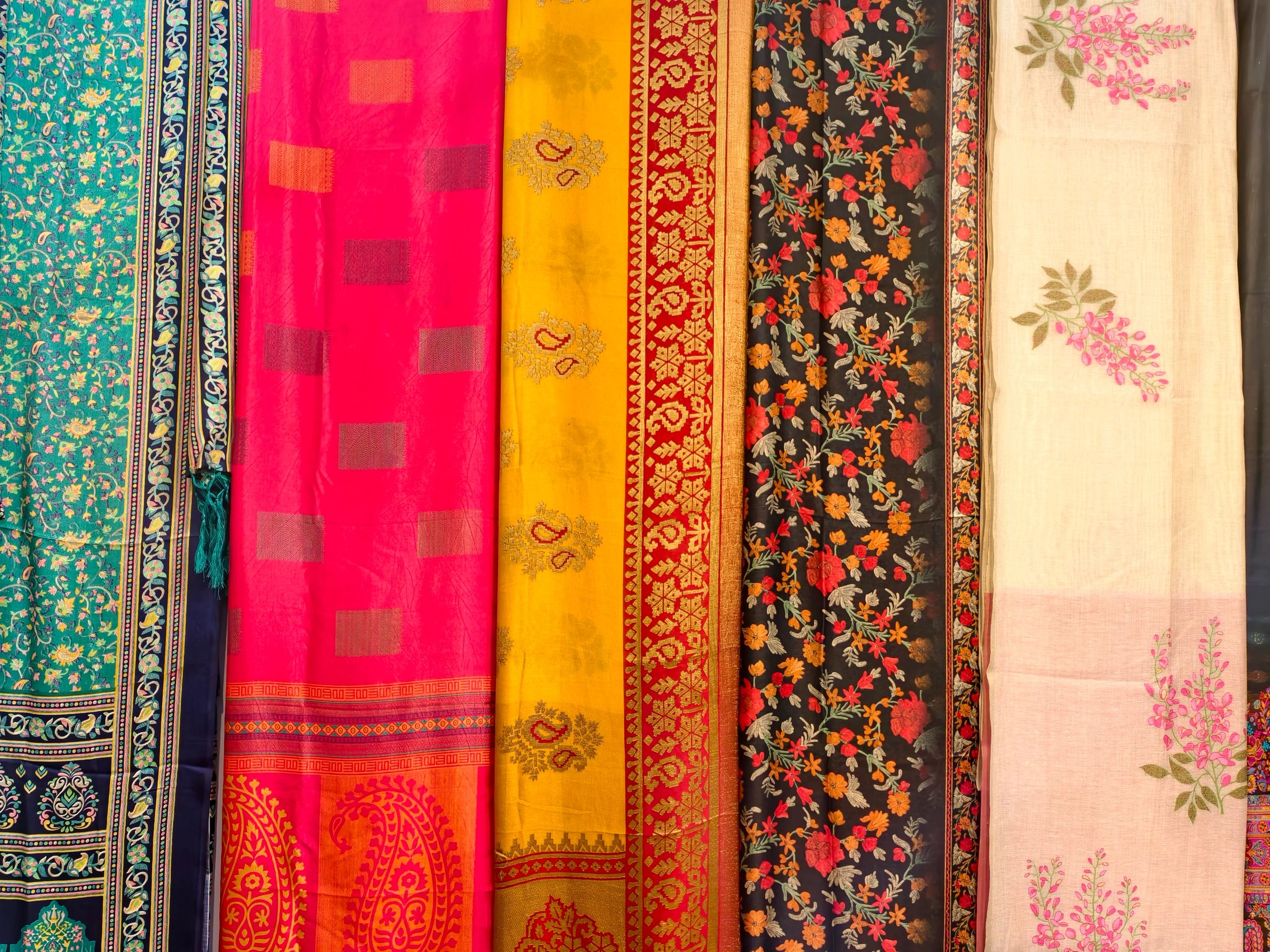 Stacked sarees displayed in a textile shop